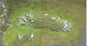 This enigmatic and unrecorded site was only recently discovered by a local resident in a remote peninsula on the island of Grimsay.  It comprises a long natural rock outcrop jutting out into a marshy area, which has at one end a curious V shaped plan structure with corbelled rubble walls and a water basin at its node point.  The image is made up of around 30 no 150kB digital stills taken off a video recorded by a Canon Ixus 220 camera suspended from a Cody kite.